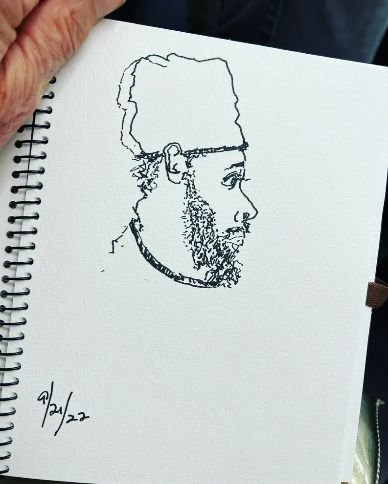 A drawing of a man with a beard and hat.