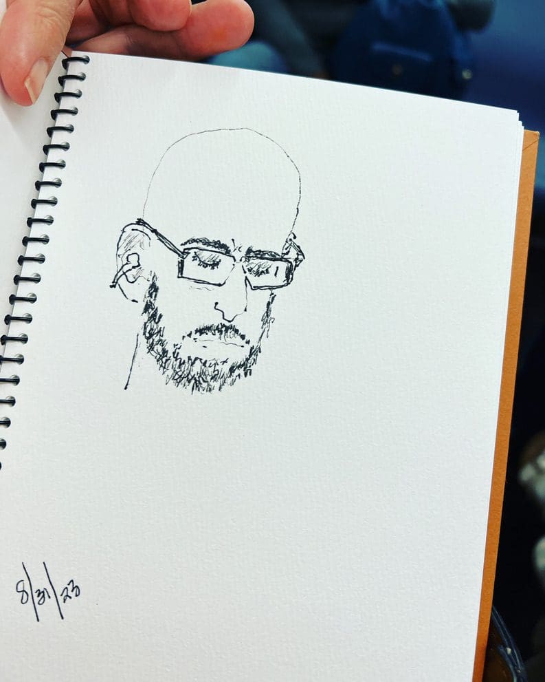 A person is drawing a picture of a man.