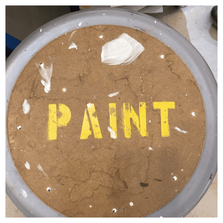 A paint can with the word " paint " written on it.