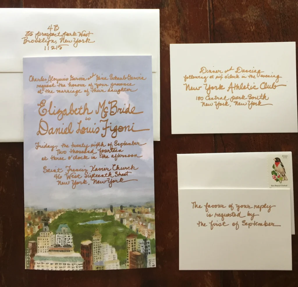 A wedding invitation with gold lettering and an envelope.